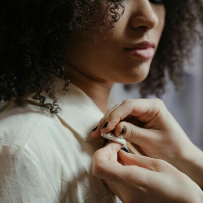 Woman in White Shirt Holding Her Hair