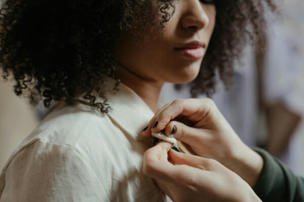 Woman in White Shirt Holding Her Hair